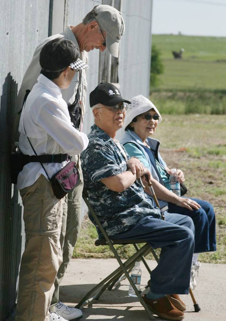 William Watanabe (center) visits with other Japanese Americans and his wife (right), Shizue Watanabe, at the Minidoka National Historic Site in Idaho. William Watanabe died in 2011, after re-visiting the place where his grandparents, parents and four siblings were sent during World War II. (Glen Watanabe)