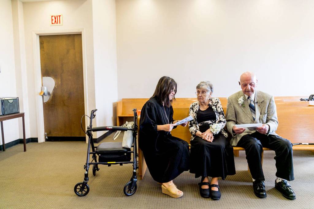 Judge Tam Bui talks with Marilyn Ogden and Kal Leichtman before their wedding ceremony Wednesday at the Snohomish County Courthouse in Everett. (Kevin Clark / The Herald)