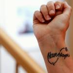 Judy Schneider-Wallace got her Have Hope tattoo while she and her children dealt with the loss of her first husband, who killed himself with a gun purchased just for that purpose. (Dan Bates / The Herald)