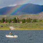 Rob Gamage of Lake Stevens fishes at Big Twin Lake under a rainbow created by a spring rain. (Mike Benbow)