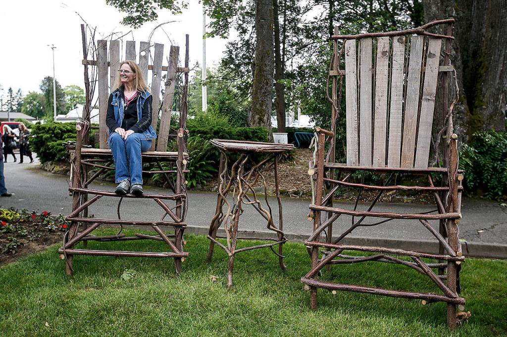 Gwen Keilman, of Everett, sits in a gigantic chair at Sorticulture. (Ian Terry/Herald file)