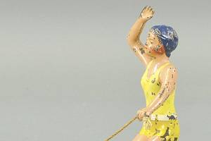 Surfer toy has wheels that let it roll on an eccentric path