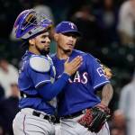Texas Rangers closing pitcher Keone Kela, right, shares congratulations with catcher Robinson Chirinos after the Rangers defeated the Seattle Mariners 7-6 in a baseball game Wednesday, May 30, 2018, in Seattle. (AP Photo/Elaine Thompson)