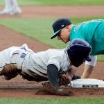 Tampa Bays Mallex Smith is caught stealing at third base with a tag by Seattles Kyle Seager during the first inning of Fridays game at Safeco Field. (AP Photo/Ted S. Warren)