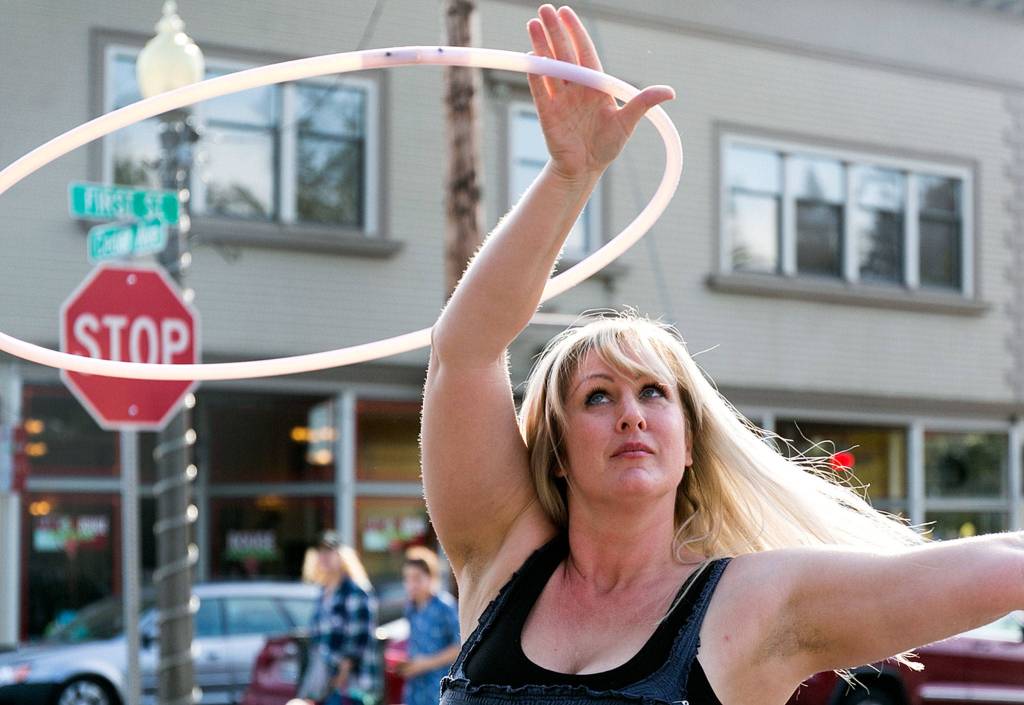 Shannon Dey performs with her handmade hoops on the first day of the Snohomish Farmers Market in Snohomish on May 3. (Kevin Clark / The Herald)