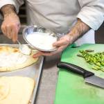 Felsenstein spreads creme fraiche on his flatbread before adding smoked salmon, asparagus, red pepper, onion and cheese. (Ian Terry/The Herald)