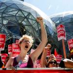 Kailyn Nicholson (center), with Socialist Alternative, continues anti-Amazon chants in front of the Spheres on Amazons campus on May 12. A different group has been collecting signatures for a referendum on the new tax. (Alan Berner/The Seattle Times via AP, file)