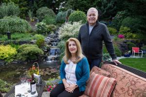 Mina and Tim Marcher in their backyard garden featuring a 30 foot waterfall, part of this years Mill Creek Garden Tour. (Andy Bronson / The Herald)