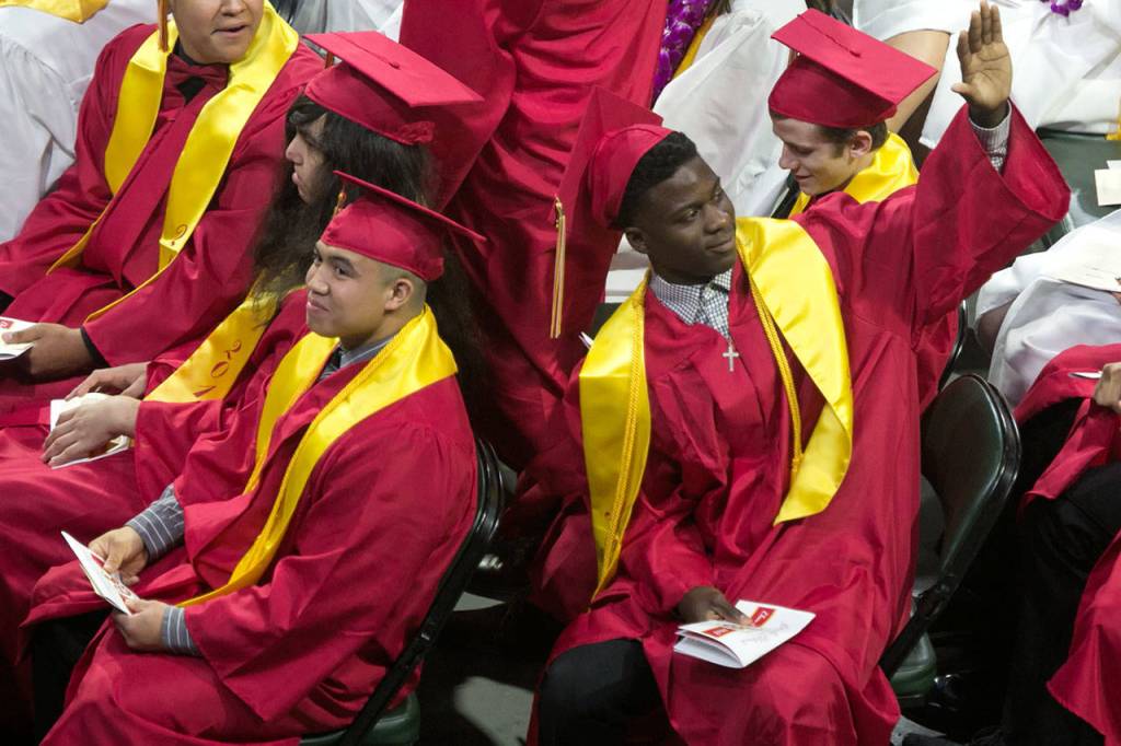 Students react to family and friends during the Marysville Pilchuck High School commencement at Angel of the Winds Arena on Wednesday night in Everett. (Kevin Clark / The Herald)