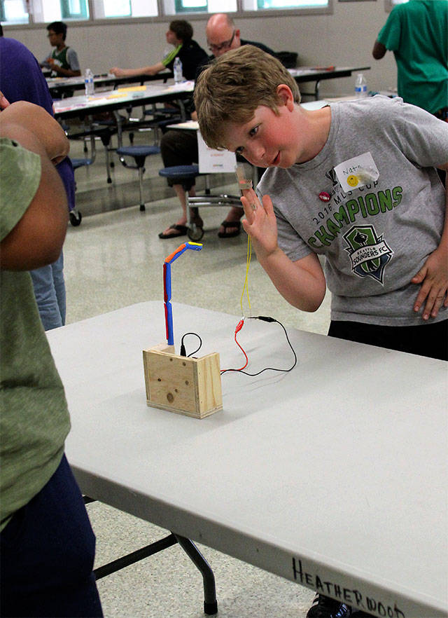 Heatherwood Middle School student Nate Brown manipulates a hand-like device during a May 23 STEM Night event with Microsoft. (Contributed photo)