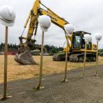 Hard hats, shovels and a backhoe decorate the site of the new Everett Family YMCA Saturday morning. (Kevin Clark / The Herald)