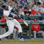 Mariners designated hitter Nelson Cruz hits a solo home run during the fourth inning of a baseball game against the Los Angeles Angels on Monday at Safeco Field in Seattle. It was his second of the game. (Ted S. Warren / Associated Press)