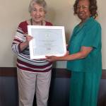 Lynnwood Councilwoman and RSVP Advisory Council member Shirley Sutton presents volunteer Judy Edgmand with a Presidents Call to Service Llifetime Service Award. (Contributed photo)