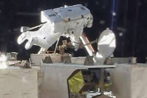 Spacewalking astronauts set up TV cameras for arriving ships
