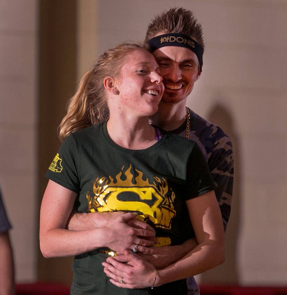 Erin Kearney is hugged by Dan Miller Thursday night during Adult Open Skate at Lynnwood Bowl and Skate in Lynnwood on June 14, 2018. (Kevin Clark / The Herald)
