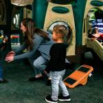In the playground at Tomorrows Hope Child Development Center in Everett, Director Erin Jackson reaches out for a young boy approaching with a hurt hand Friday. (Dan Bates / The Herald)