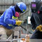 Nichols Brothers Boat Builders apprentice Janette Alhanati (left) and journeyman Kurt Warwick construct wall panels for an upcoming boat project with Linblad Expedition Holdings. A federal grant from the Northwest Workforce Council allowed Nichols Brothers to add more apprentices to its workforce in January. (Herald file photo)