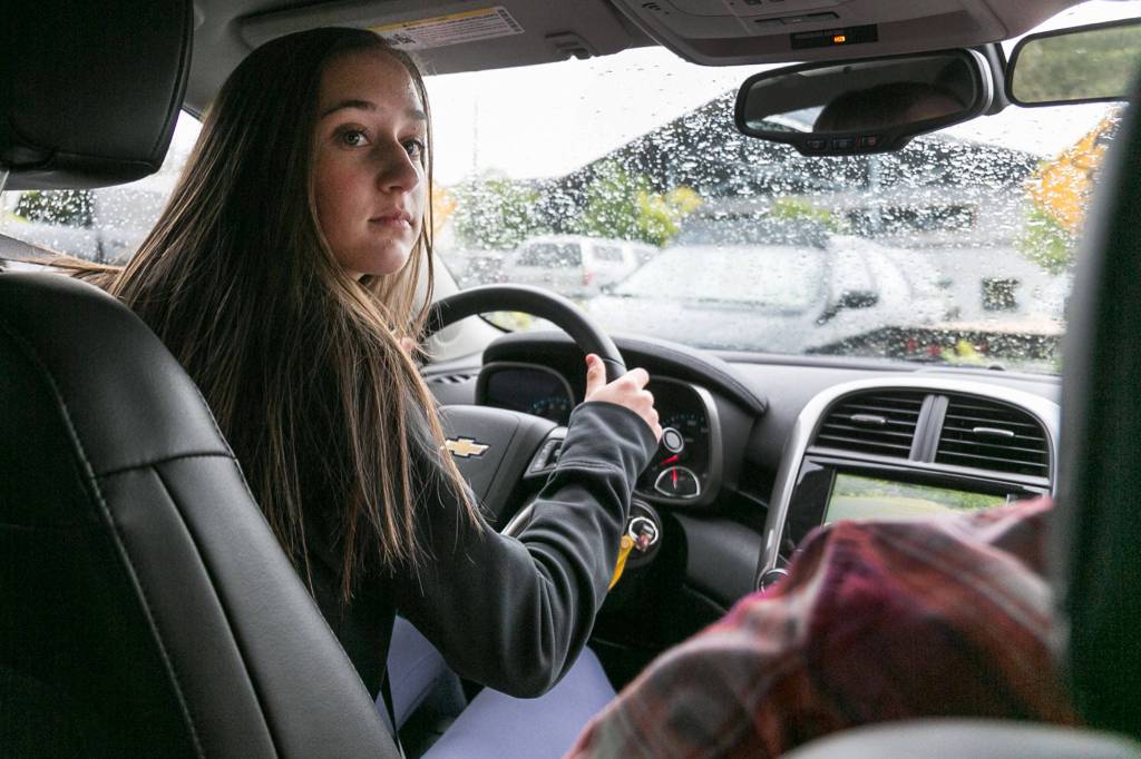 Olivia Kraski takes a turn at the wheel for drivers eduction class at Arlington High School on June 8. (Kevin Clark / The Herald)