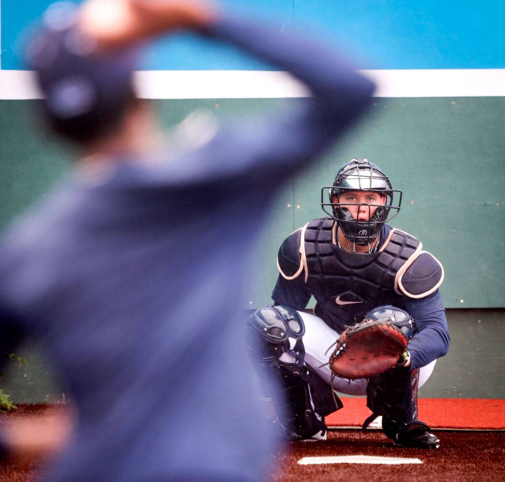 Troy Dixon (right) eyes Dayrison Arias for a pitch during practice at Everett Memorial Stadium in Everett on June 12. (Kevin Clark / The Herald)