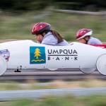 Amelia Allen (left) looks down at the track as she races another driver in unweighted practice soap box derby cars on June 7 in Camano Island. (Andy Bronson / The Herald)