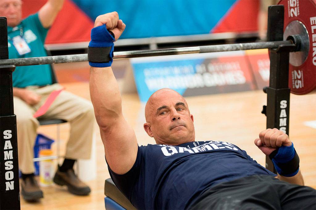 Navy Reservist Corpsman Senior Chief Joe Paterniti cheers for Team Navy after competing in powerlifting June 5, 2018, at the U.S. Air Force Academy in Colorado Springs, Colorado, during the 2018 Department of Defense Warrior Games. (DoD photo by Roger Wollenberg)                                Navy Reservist Corpsman Senior Chief Joe Paterniti cheers for Team Navy after competing in powerlifting June 5 at the U.S. Air Force Academy in Colorado Springs, Colorado, during the 2018 Department of Defense Warrior Games. (DoD photo by Roger Wollenberg)
