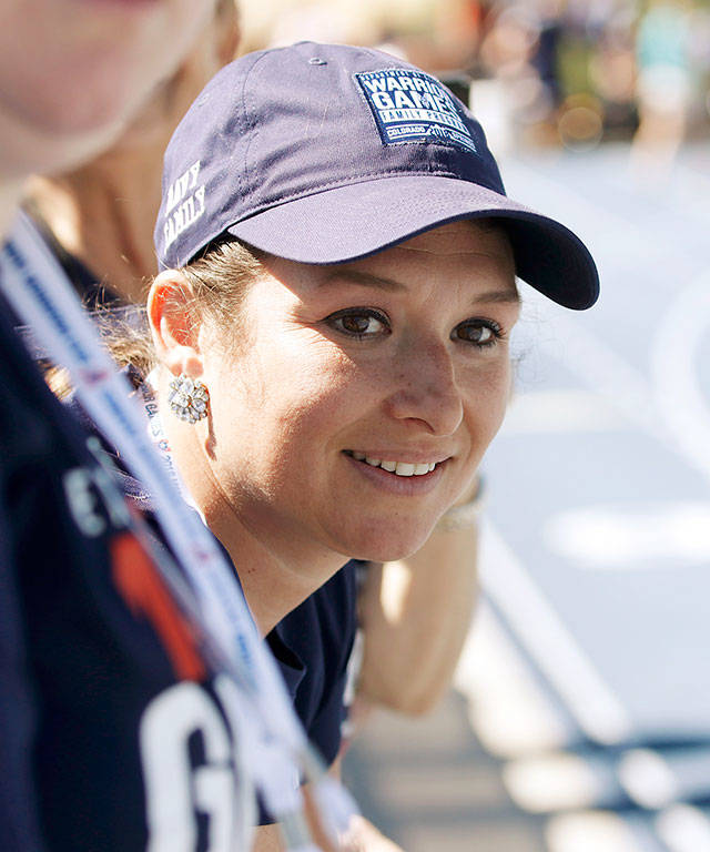 Monica Vaughn, from Bakersfield, California, watches her husband, Chief Petty Officer Tim Vaughn, of Marysville, Washington, compete in the mens 800 meters during the Department of Defense Warrior Games on Saturday, June 2, 2018, at the U.S. Air Force Academy near Colorado Springs, Colorado. Monica cheered Tim on from the stands for each of his track events. (Photo/Christina R. Matacotta, Grady Sports Bureau)