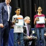 Gateway Middle School students Arjun Vinodhan and Sushmita Musunori each receive Economic Alliance Snohomish County and Snohomish STEM Network Future Innovator Awards from Patrick Pierce, CEO of Economic Alliance. (Contributed photo)