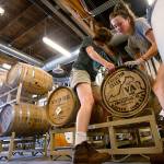 Workers move a barrel of whiskey in the Catoctin Creek Distillery in Purcellville, Virginia, on Wednesday. Based on market trends about one-fourth of the rye whiskey inventory could end up being consumed in Europe, a market the 9-year-old distilling company has cultivated at considerable cost. (AP Photo/Steve Helber)