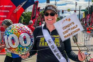Lynnwoods Cindy Ward, 42, completed her 100th half marathon earlier this month. Here, she celebrates at the finish line of the Rock n Roll Seattle Half Marathon at Seattle Center. (Photo courtesy Cindy Ward and Gretchen Tapp)