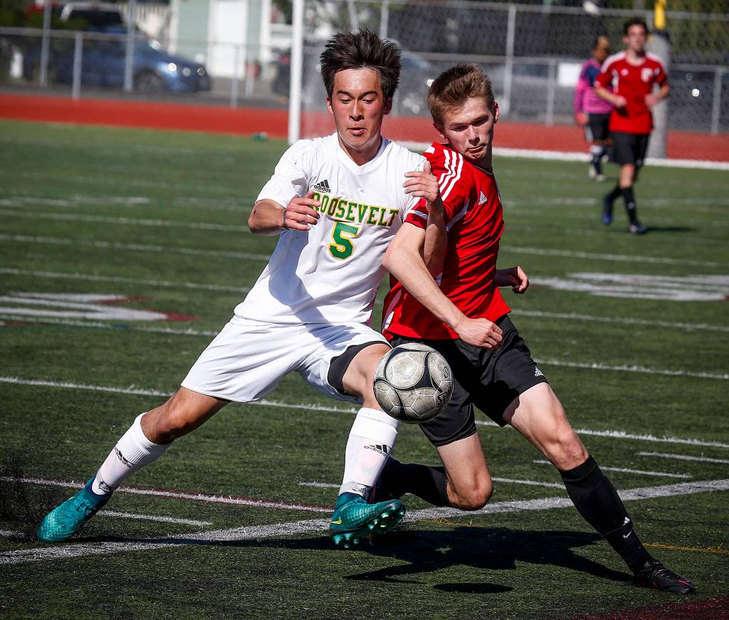 Snohomishs Conner Smith (right) gets pushed off the ball by Roosevelts Mattias Cochard during the 2017 3A State Championship at Sparks Stadium in Puyallup. (Ian Terry / Herald file)