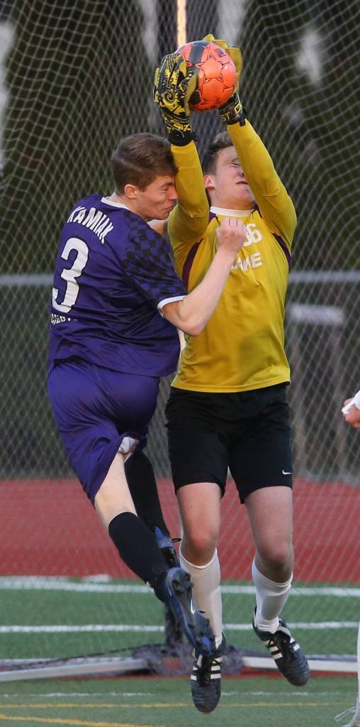 Kamiaks Cade Cooke runs into Lake Stevens goalie JJ Smith as Kamiak beat Lake Stevens 2-1 in a soccer match Tuesday, April 24, 2018 in Lake Stevens. (Andy Bronson / The Herald)