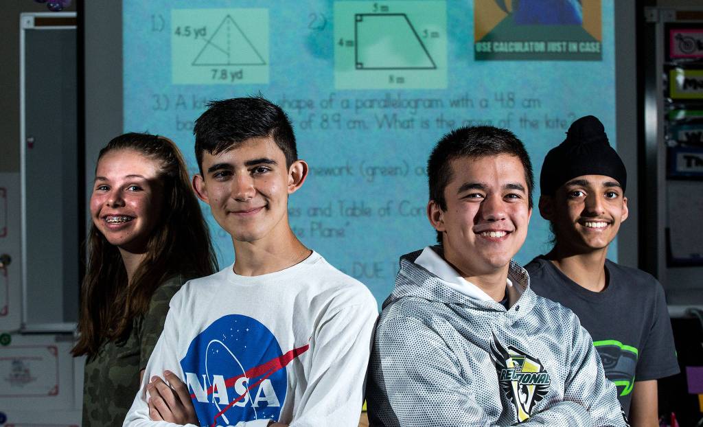 Katelyn Pryor, Diego Corpening, Dylan Austin and Prabhman Aujla take high school level credit classes while attending Eisenhower Middle School on June 11 in Everett. (Andy Bronson / The Herald)