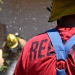 Recruits practice with a firehose during a mock house fire on May 23 as part of Snohomish Countys first fire academy. (Caleb Hutton / The Herald)