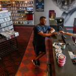 Dan Bates / The Herald                                Yvonne Seeber, 43, who has worked at Silver Lake Video for 18 years, handles a purchase by Ashraf Mabrouk, of Everett. Mabrouk says he likes this store and has been a customer for 10 years.