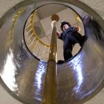 Firefighter Travis Smith gets ready to slide down the fire pole at Everett Fire Department Station 1. The pole is the only one remaining at an Everett firehouse. (Andy Bronson / The Herald)