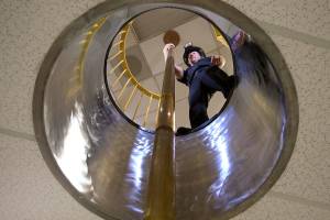 Firefighter Travis Smith gets ready to slide down the fire pole at Everett Fire Department Station 1. The pole is the only one remaining at an Everett firehouse. (Andy Bronson / The Herald)