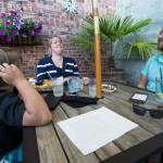 Becca Selin and her son, Brody, share a laugh with Erik Marty during Taco Tuesday at Sol Food Bar and Grill in Everett. Marty put out a question looking for a dining companion on a Facebook dining page. Within 90 minutes, Selin answered and brought along Brody, 7. (Andy Bronson / The Herald)