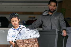Guillermo Mario Jiménez unloads the moving truck at his familys new home in Everett. (Kevin Clark / The Herald)