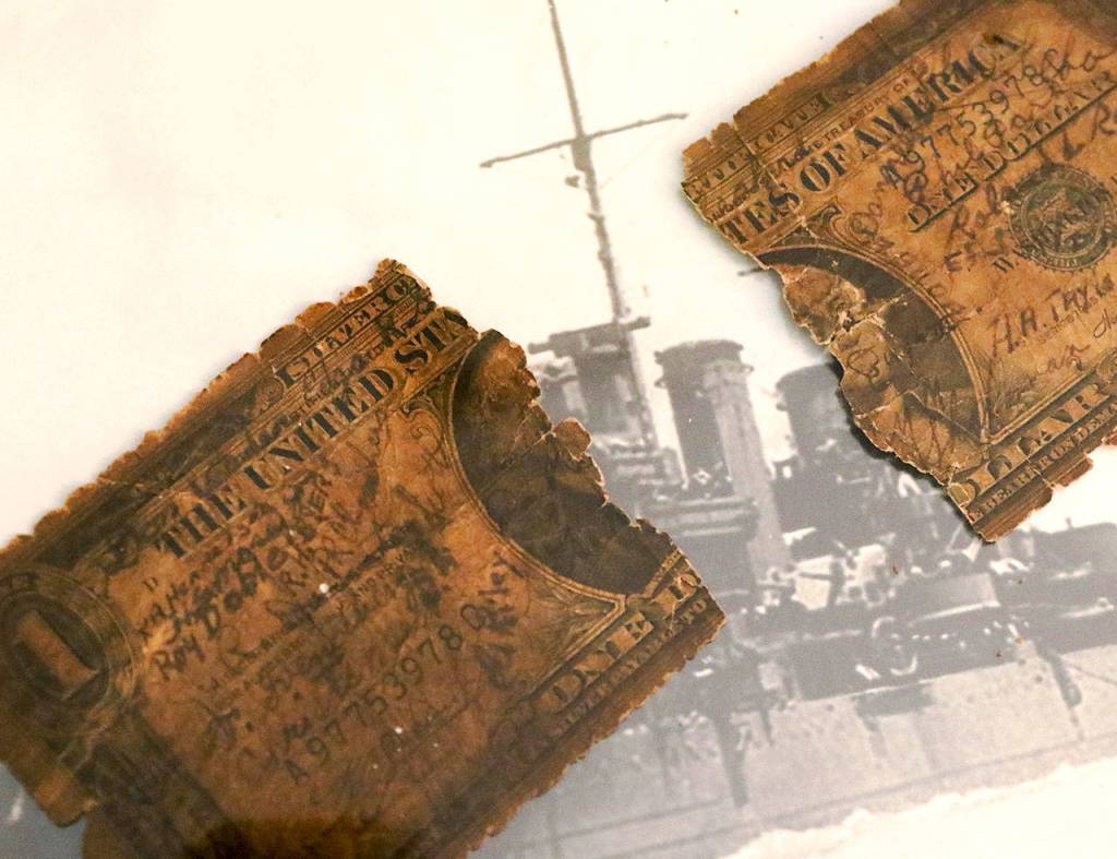 Edgar Shepherds surviving dollar bill from the sinking of the USS Helena. (Kevin Clark / The Herald)