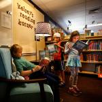 Darren Howe, 9, sits in a comfy chair reading Harry Potter and the Sorcerers Stone while his cousin, Naven Collins, 7, (center) stands delighting in a Elephant and Piggie book, which is from the same collection that Mya Illingworth, 6, (back middle) is looking through in Kelseys reading Korner at Sunnycrest Elementary School Wednesday. With the addition of Kelseys Korner, featuring the kind of books she encouraged her kids to read, the school now has two places that honor Kelsey Osborne, a much loved teacher who died in June. (Dan Bates / The Herald)