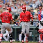The Angels Kole Calhoun is greeted by David Fletcher after hitting a home run, while Mariners catcher Chris Herrmann looks away during the sixth inning on July 4, 2018, in Seattle. (AP Photo/John Froschauer)