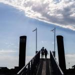 A couple makes their way up the walkway to Jetty Island on Thursday in Everett. (Olivia Vanni / The Herald)