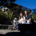 Kelsey and Jesse Woodson with their dog, Roger, in their garden in Edmonds. The Woodsons garden will be one of a handful of gardens featured in the Edmonds In Bloom garden tours on July 15. (Olivia Vanni / The Herald)