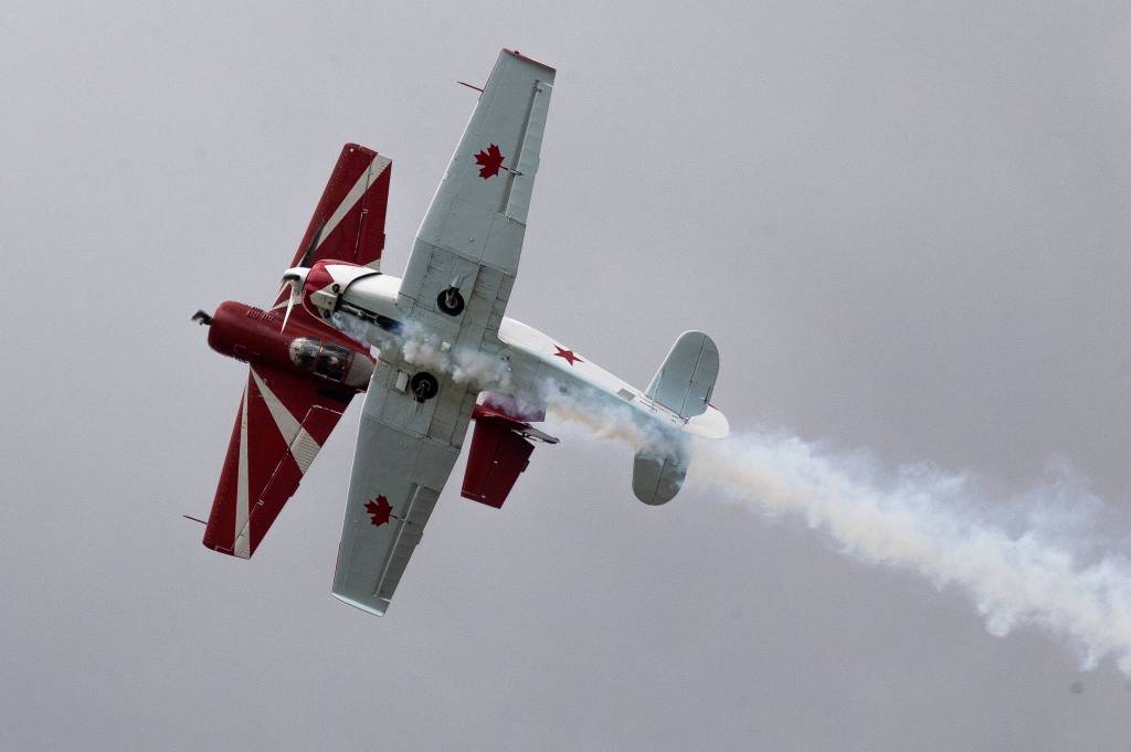 Flying a YAK-55 and a YAK-18T, Bud and Ross Granley fly in formation during a performance at the 50th annual Arlington Fly-In at the Arlington Airport on Saturday. The duo are father and son. (Andy Bronson / The Herald)