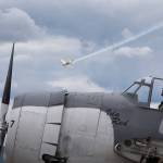While sitting in the cockpit of the Grumman TBM-3E Avenger Ida Red, pilot Michael Kopp gets his plane ready as another plane performs at the 50th annual Arlington Fly-In at the Arlington Airport on Saturday. (Andy Bronson / The Herald)