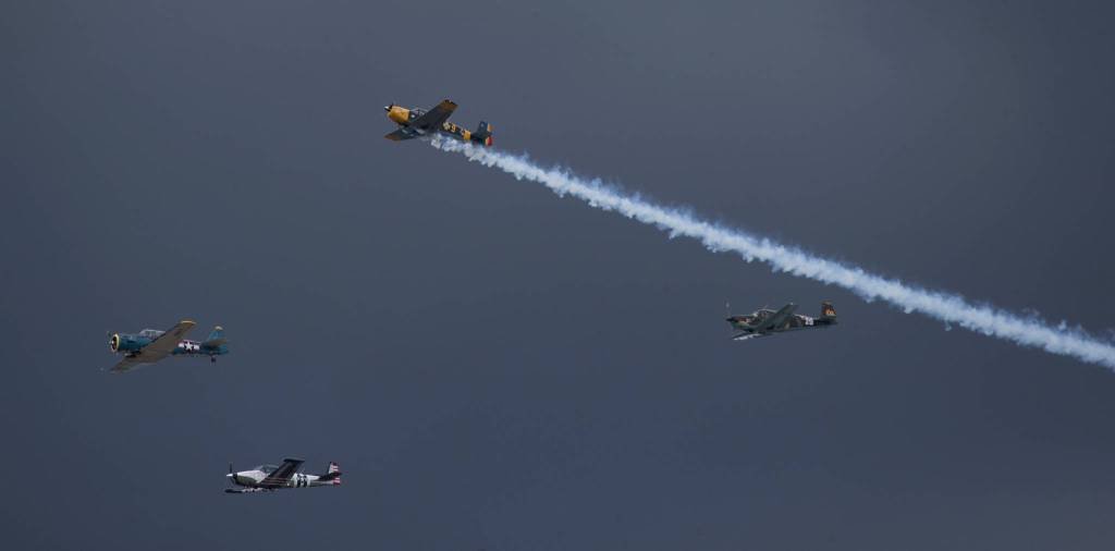 A plane trails smoke as he exits a formation at the 50th annual Arlington Fly-In at the Arlington Airport on Saturday. (Andy Bronson / The Herald)