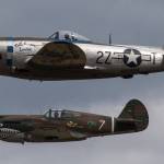 A P-47 Thunderbolt (top) passes a P-40 Tomahawk during maneuvers at the 50th annual Arlington Fly-In at the Arlington Airport on Saturday. (Andy Bronson / The Herald)