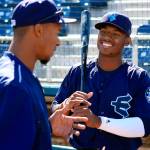 Mariners first-round pick Kyle Lewis (right) talks with AquaSox hitting coach Brian Hunter on June 16, 2018, at Everett Memorial Stadium. (Kevin Clark / The Herald)