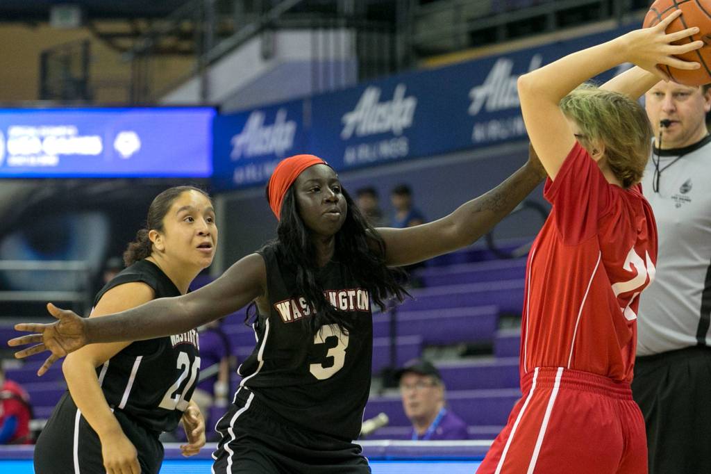 Washingtons Agwin Atem (center) defends against Texas Liane Matzenbach and Washingtons Melany Hernandez (left) during the 2018 Special Olympics USA Games Basketball at Alaska Airlines Arena at Hec Edmundson Pavilion in Seattle on July 5. Read their Silver Medal story <a href="https://www.heraldnet.com/sports/washington-earns-female-hoops-silver-medal-at-special-olympics/" target="_blank">here</a>. (Kevin Clark / The Herald)