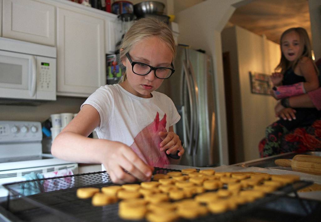 Zoe Bennett, 10, cuts out heart-shaped dog treats in her kitchen on June 28 in Marysville. Read about how she sells them to raise money for her best friends cancer treatments <a href="https://www.heraldnet.com/news/when-phenyx-was-diagnosed-with-cancer-zoe-didnt-hesitate/" target="_blank">here</a>. (Olivia Vanni / The Herald)